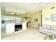 Open floor plan with a white kitchen island that includes a TV and living room area with a couch and ceiling fan at 5250 Hyland Hills Ave # 1514, Sarasota, FL 34241