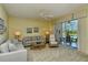 Bright living room features neutral tones, ceiling fan, and scenic view at 5250 Hyland Hills Ave # 1514, Sarasota, FL 34241