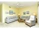 Living room featuring plush seating arrangements and serene wall art at 5250 Hyland Hills Ave # 1514, Sarasota, FL 34241