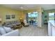 A spacious living room with comfortable seating and a sliding door to the lanai at 5250 Hyland Hills Ave # 1514, Sarasota, FL 34241