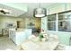 From dining area view into kitchen and living area with ceiling fans and beach themed artwork throughout at 5250 Hyland Hills Ave # 1514, Sarasota, FL 34241