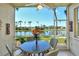 Relaxing screened patio with ceiling fan overlooking a serene lake and lush greenery at 5250 Hyland Hills Ave # 1514, Sarasota, FL 34241