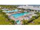Aerial view of the community pool area, showcasing multiple pools, seating, and lush landscaping at 5317 Coral Reef Way, Bradenton, FL 34211
