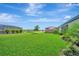 Beautiful home featuring a large backyard with plush landscaping and a well-manicured lawn at 5317 Coral Reef Way, Bradenton, FL 34211