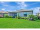 A peaceful backyard with a covered lanai, lush landscaping and plentiful green grass at 5317 Coral Reef Way, Bradenton, FL 34211