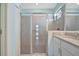 Bathroom with a glass-enclosed shower, sink, and white cabinets at 5317 Coral Reef Way, Bradenton, FL 34211