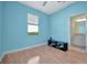 Bedroom with wood floors, light blue walls, and a window with a view to outside at 5317 Coral Reef Way, Bradenton, FL 34211
