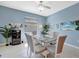 Dining area features a glass top table, seating for six, and stylish light fixture at 5317 Coral Reef Way, Bradenton, FL 34211