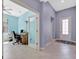 Hallway view leading to a home office with tile flooring and neutral paint at 5317 Coral Reef Way, Bradenton, FL 34211