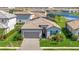Charming single-story home featuring a well-manicured lawn and a gray brick driveway at 5317 Coral Reef Way, Bradenton, FL 34211