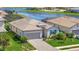 Beautiful single-story home with a paver driveway and tile roof near a serene lake at 5317 Coral Reef Way, Bradenton, FL 34211