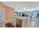 Island kitchen with stainless steel appliances, granite countertops and view of living space at 5317 Coral Reef Way, Bradenton, FL 34211