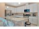 Beautiful kitchen with stainless steel appliances, granite countertops, and modern bar stools at 5317 Coral Reef Way, Bradenton, FL 34211