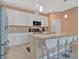 Bright kitchen featuring a large island with bar seating and stainless steel appliances at 5317 Coral Reef Way, Bradenton, FL 34211