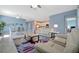 Living area features white leather sofas, tiled floors, and contemporary decor at 5317 Coral Reef Way, Bradenton, FL 34211