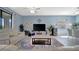 Spacious living room features large screen tv, tiled floors, and contemporary decor at 5317 Coral Reef Way, Bradenton, FL 34211