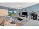 Bright living room showcasing tile floors, cozy seating, and a view of the lanai at 5317 Coral Reef Way, Bradenton, FL 34211