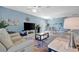 Open-concept living room features tile floors, modern ceiling fan, and inviting seating area at 5317 Coral Reef Way, Bradenton, FL 34211
