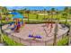 A colorful playground with slides, swings, and a seesaw offers a fun and safe play area at 5317 Coral Reef Way, Bradenton, FL 34211