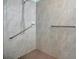 Accessible shower with grab bars and tile flooring at 5317 Coral Reef Way, Bradenton, FL 34211