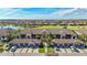 Stunning aerial view of the condos with lush landscaping, a lake, and golf course at 5517 Palmer Cir # 203, Bradenton, FL 34211