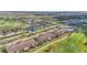 Aerial view of property featuring golf course, ponds, community pool, and residences at 5517 Palmer Cir # 203, Bradenton, FL 34211