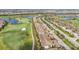 Beautiful aerial view of the community showcasing the golf course, ponds and rows of townhomes with tile roofs at 5517 Palmer Cir # 203, Bradenton, FL 34211