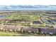 Aerial view of golf course community with many houses, ponds, and green golf courses at 5517 Palmer Cir # 203, Bradenton, FL 34211