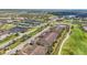 Aerial view of resort property with residences, tennis courts, golf course, and ponds at 5517 Palmer Cir # 203, Bradenton, FL 34211