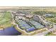 Overhead view showcasing the tennis courts, community pool, and lush landscaping in the beautiful community at 5517 Palmer Cir # 203, Bradenton, FL 34211