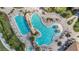 Overhead view of a resort-style pool with ample seating and tropical landscaping at 5517 Palmer Cir # 203, Bradenton, FL 34211
