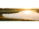 Scenic view of a golf course and lake at sunset at 5517 Palmer Cir # 203, Bradenton, FL 34211