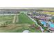 Aerial view of the community golf course, pool, clubhouse, and lush tropical landscaping at 5517 Palmer Cir # 203, Bradenton, FL 34211