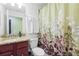 Cozy bathroom with granite counters, toilet, sink and shower curtain at 5517 Palmer Cir # 203, Bradenton, FL 34211