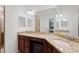 Bathroom featuring double sinks with granite countertops, vanity area, and large mirror at 5517 Palmer Cir # 203, Bradenton, FL 34211