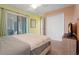 Light bedroom featuring large slider door, ceiling fan, and closet at 5517 Palmer Cir # 203, Bradenton, FL 34211
