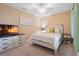 Bright bedroom featuring a ceiling fan, TV, and dresser at 5517 Palmer Cir # 203, Bradenton, FL 34211