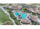 Aerial view of the resort style community pool with lounge chairs and tropical landscaping at 5517 Palmer Cir # 203, Bradenton, FL 34211