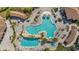 Beautiful overhead view of the resort style community pool surrounded by lounge chairs and palm trees at 5517 Palmer Cir # 203, Bradenton, FL 34211