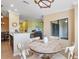 Sunlit dining area boasts a round table, modern lighting, and seamless flow into the living space at 5517 Palmer Cir # 203, Bradenton, FL 34211