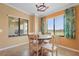 Bright dining area features a round table, tropical-themed curtains, and lots of natural light at 5517 Palmer Cir # 203, Bradenton, FL 34211