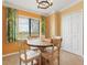 Bright dining room with wood table, stylish chairs, and sunny window views at 5517 Palmer Cir # 203, Bradenton, FL 34211