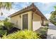 Condo exterior featuring a Spanish tile roof, landscaped bushes and stucco exterior at 5517 Palmer Cir # 203, Bradenton, FL 34211