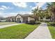 Charming condo exterior with well-manicured lawn, brick driveway and a gray two-car garage at 5517 Palmer Cir # 203, Bradenton, FL 34211