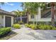 Exterior of a home featuring screened in porches, stone pathways, and tropical landscaping at 5517 Palmer Cir # 203, Bradenton, FL 34211