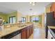 Open kitchen with breakfast bar, stainless steel appliances, and a view of the dining area at 5517 Palmer Cir # 203, Bradenton, FL 34211