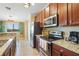 Stylish kitchen with stainless steel appliances, tile floors, and modern wooden cabinetry at 5517 Palmer Cir # 203, Bradenton, FL 34211