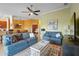 Open-concept living room with comfortable seating, a ceiling fan, and views into the dining area at 5517 Palmer Cir # 203, Bradenton, FL 34211