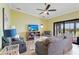 Cozy living room with comfortable seating, a ceiling fan, and access to the outdoor patio at 5517 Palmer Cir # 203, Bradenton, FL 34211