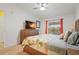 Serene main bedroom with a tropical-themed comforter and window at 5517 Palmer Cir # 203, Bradenton, FL 34211
